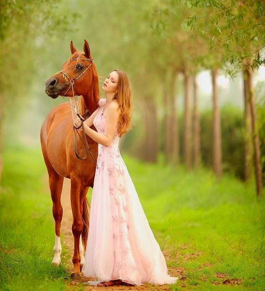 girl in dress with horse
